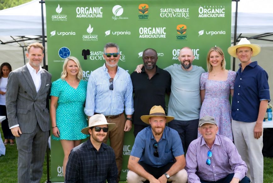 farmers in an event step and repeat banner